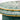 Bone inlay coffee table featuring intricate radial floral pattern in green and white, handcrafted furniture piece