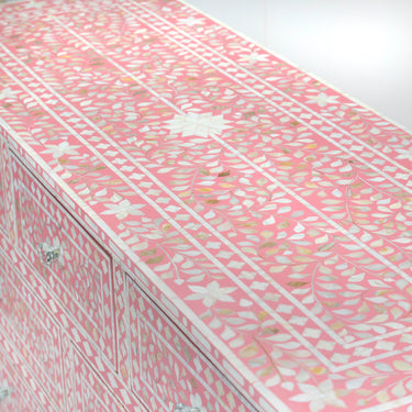 Mother of pearl inlay chest of drawers featuring intricate floral pattern in pink and white, handcrafted furniture piece