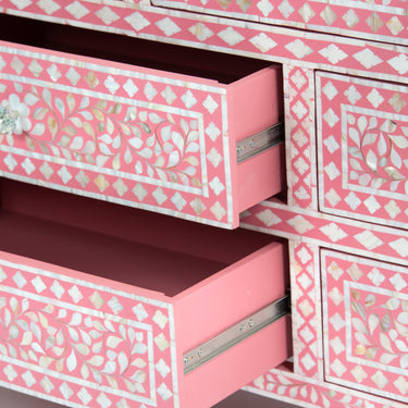 Mother of pearl inlay chest of drawers featuring intricate floral pattern in pink and white, handcrafted furniture piece