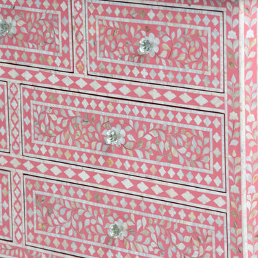 Mother of pearl inlay chest of drawers featuring intricate floral pattern in pink and white, handcrafted furniture piece
