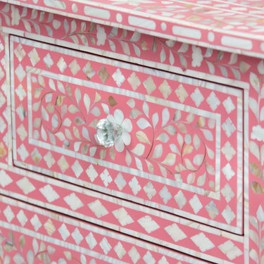 Mother of pearl inlay chest of drawers featuring intricate floral pattern in pink and white, handcrafted furniture piece