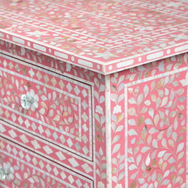 Mother of pearl inlay chest of drawers featuring intricate floral pattern in pink and white, handcrafted furniture piece